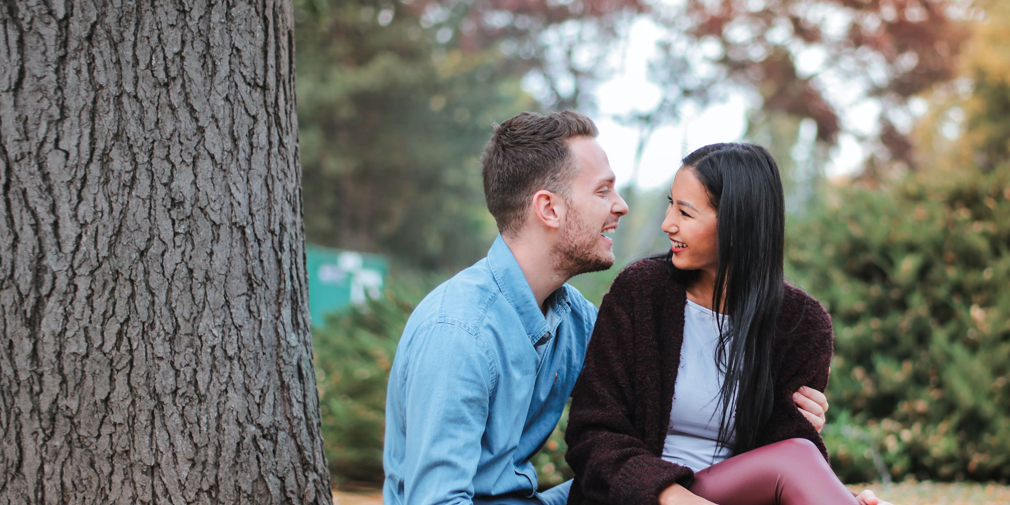 Couple sitting together under a tree having good conversation