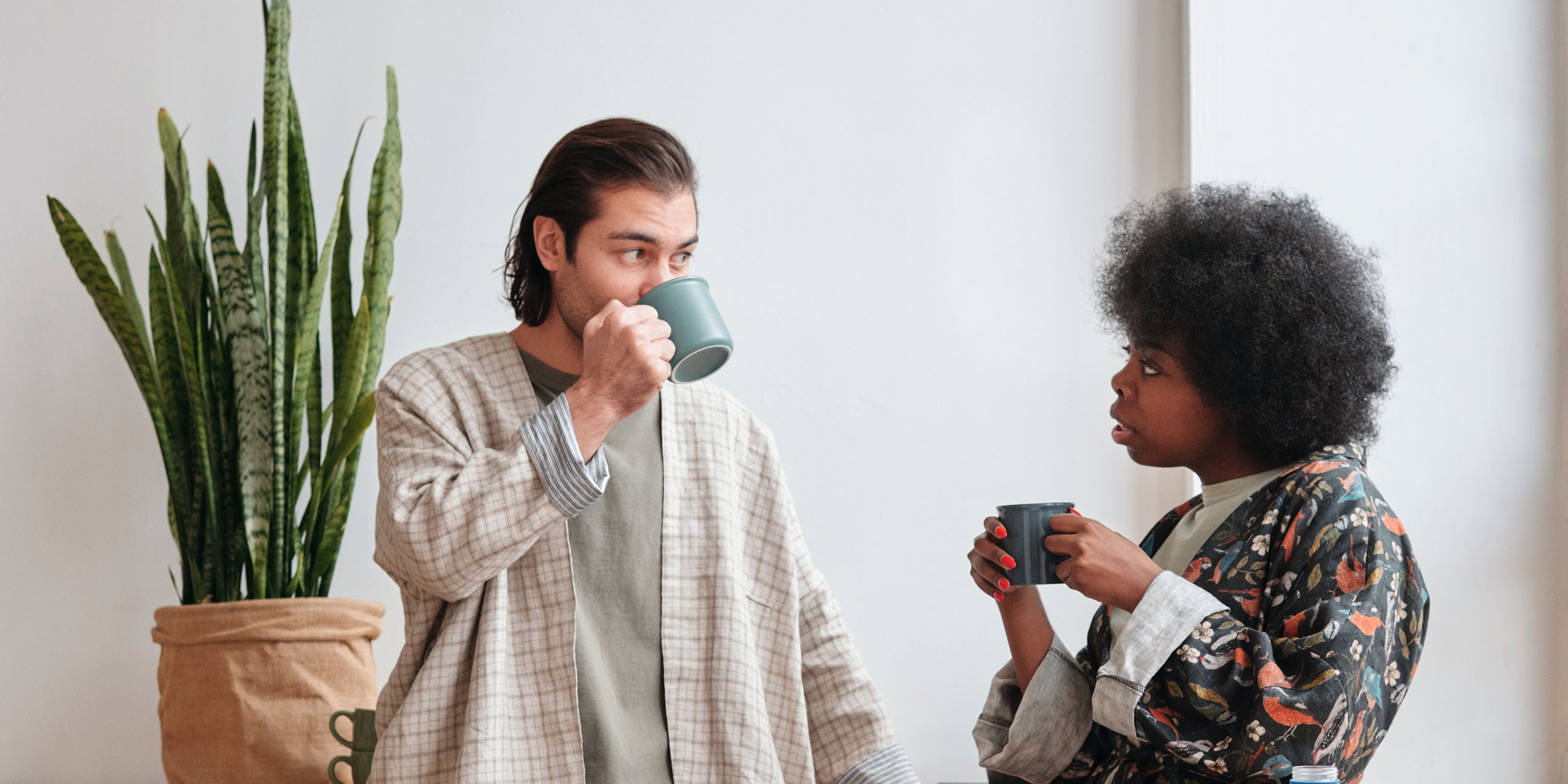Couple talking while sharing coffee together in their dining room